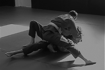 Jiu Jitsu position of knee on belly being used to pin another martial artist down